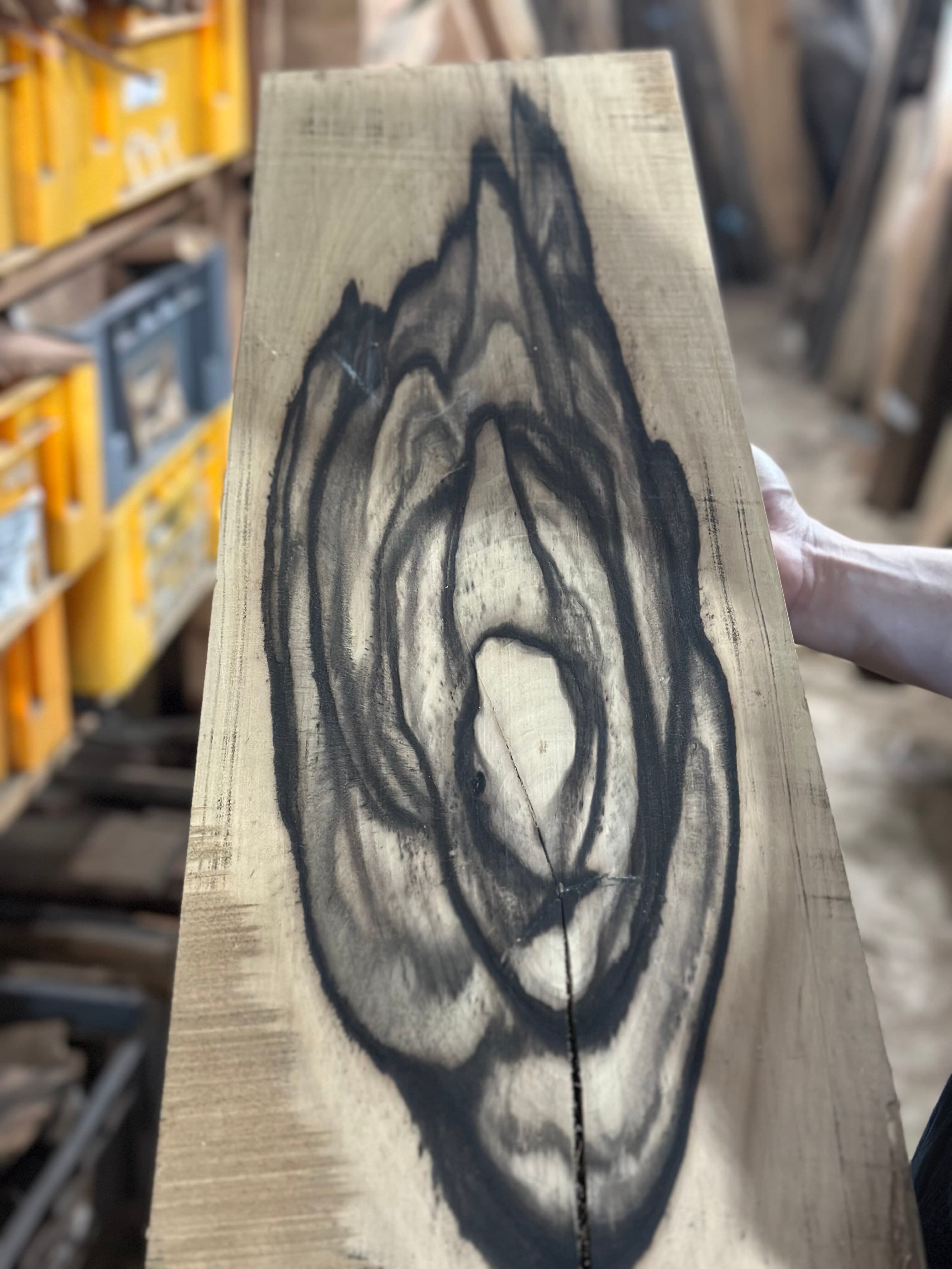 The ink-like grain of old persimmon wood